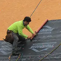 Man working on roof.